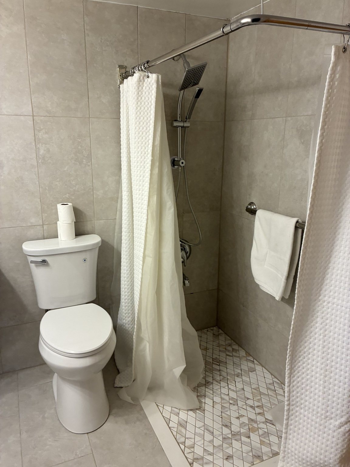 Completed tiled shower walls and fixtures