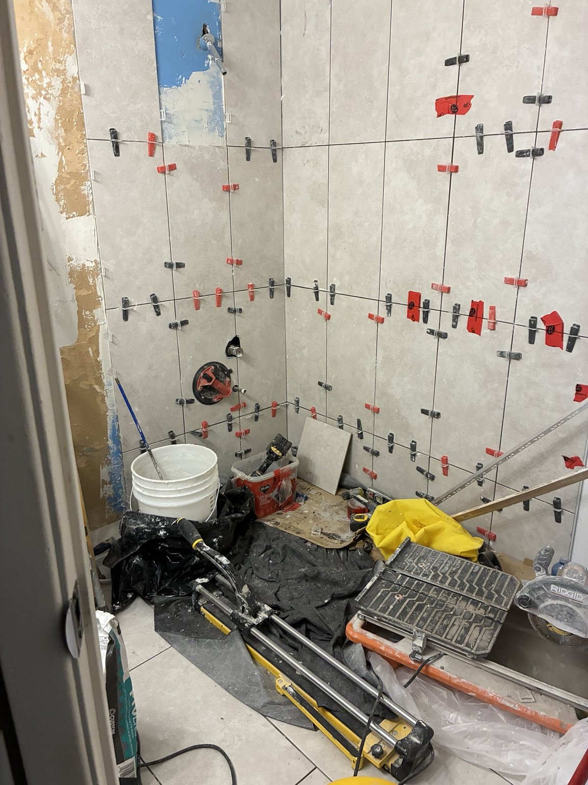 Large-format shower wall tile installation